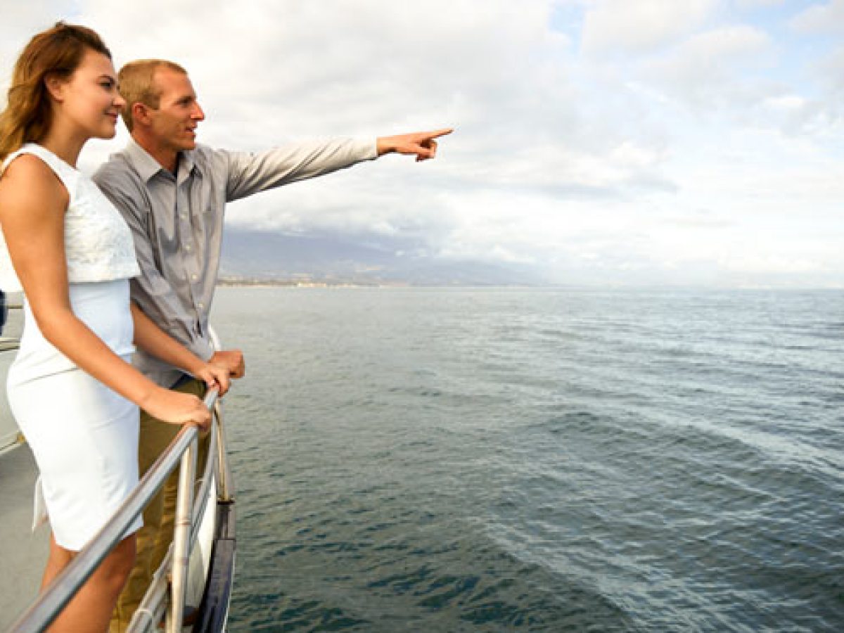 a person standing next to a body of water