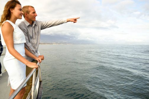 a person standing next to a body of water