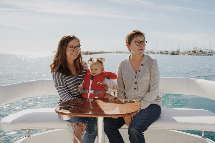 a person sitting at a table in front of a body of water