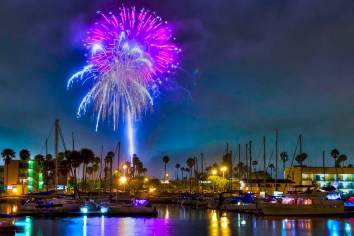 fireworks in the night sky over a body of water